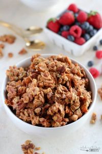 white bowl of grain free paleo granoa with berries in the background