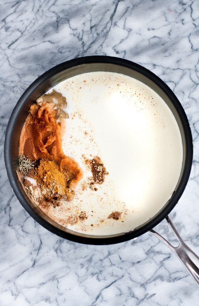 pumpkin sunbutter soup ingredients poured into a large pot over medium heat