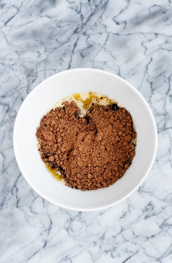 cocoa powder and melted butter in a microwave-safe bowl