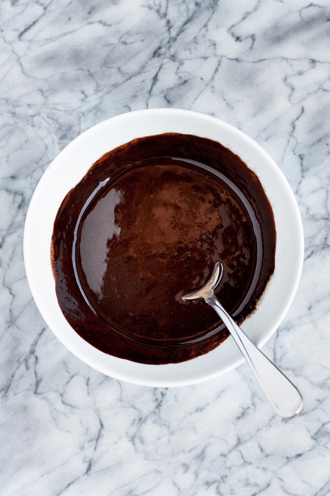 Stirred in cocoa powder into melted butter until well-combined