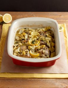 Red dish of Baked Lemon Artichoke Chicken Picatta
