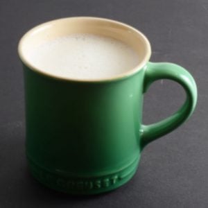Green mug of white hot chocolate