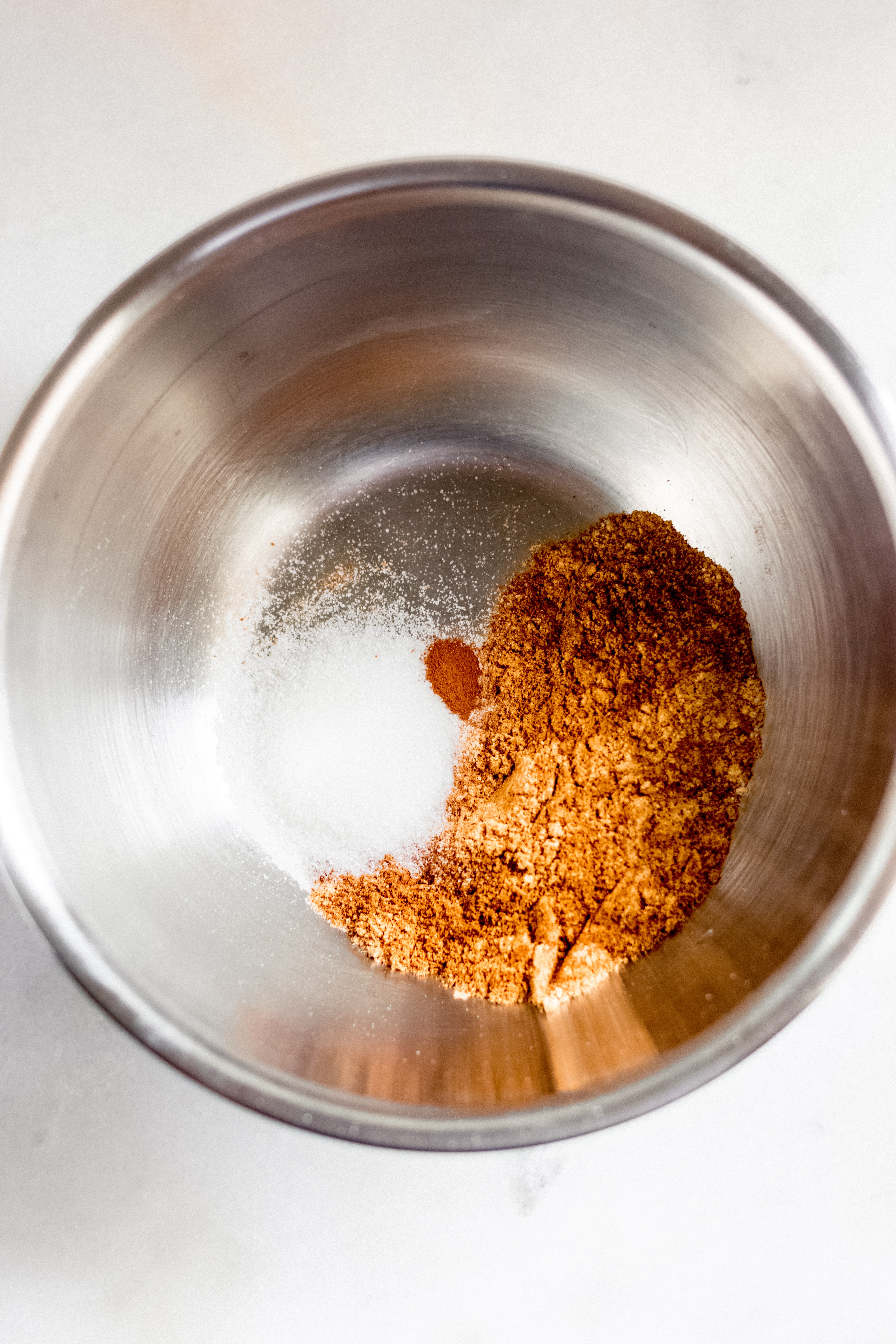 Toasted coconut flour, monk fruit sweetener and cinnamon mixed in a bowl image