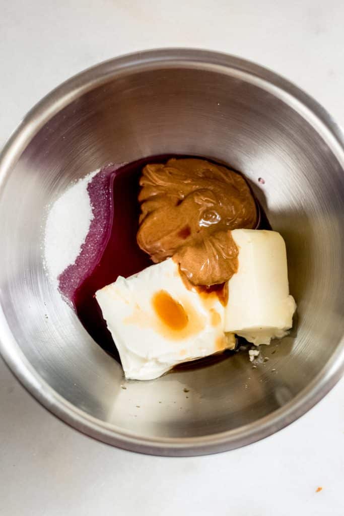 cream cheese, butter, SunButter, remaining 3 tbsp monk fruit sweetener, pinot noir, and vanilla extract in a bowl image