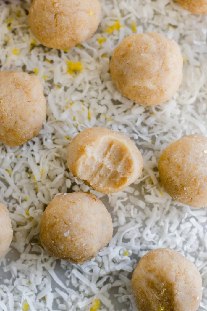 lemon bar fat bombs on a bed of desiccated coconut