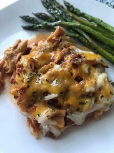 1 serving of BBQ chicken casserole on a plate with asparagus