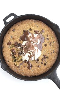 skillet chocolate chip cookie topped with ice cream and chocolate