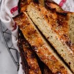 keto cheesy breadsticks on a wire basket lined with a cloth table napkin