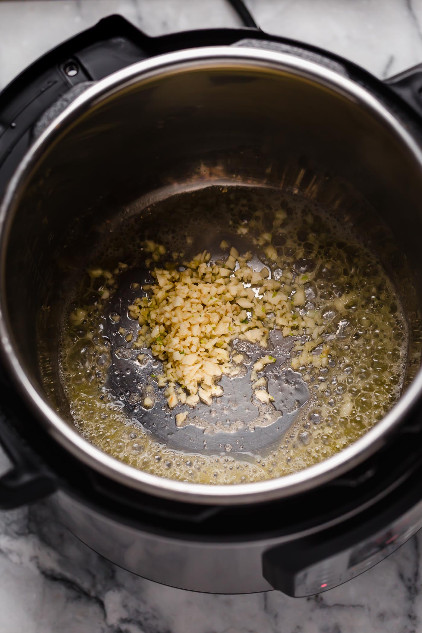 instant pot set on saute with butter and garlic