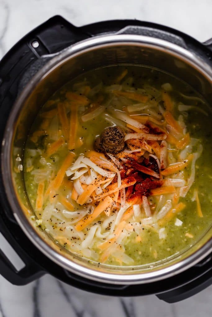 broth with cooked broccoli cheese and spices in instant pot