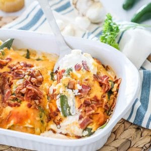 white dish of jalapeño popper chicken casserole with ingredients in the background