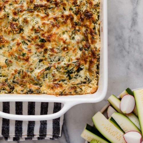 hero shot jalapeño spinach artichoke dip baked in a small square baking dish