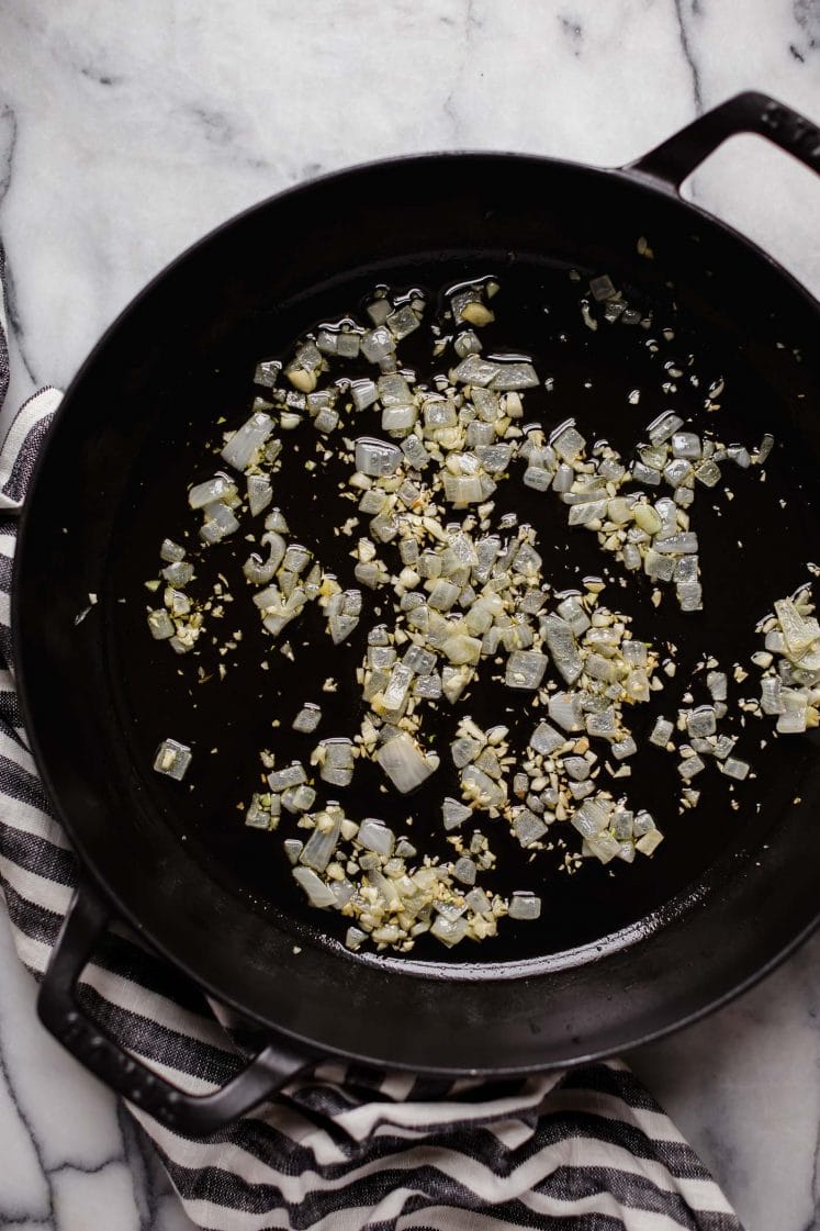 chopped onion and minced garlic sauteed in avocado oil on a large cast iron sauce pan
