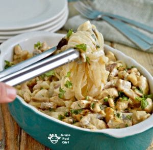 Noodles being pulled out of a dish of chicken alfredo with kelp noodles