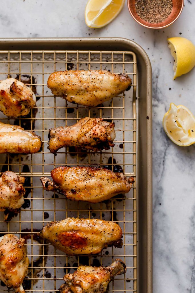 marinated lemon pepper chicken wings baked and resting on a baking rack