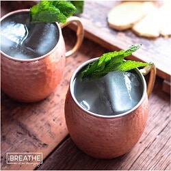 2 servings of low carb moscow mules on a wooden surface