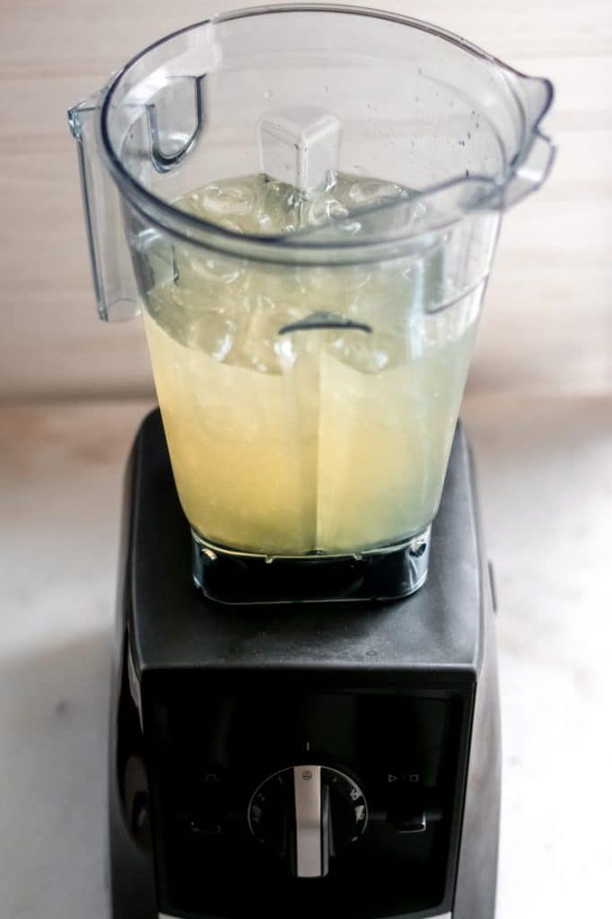 champagne margarita ingredients and ice in a blender