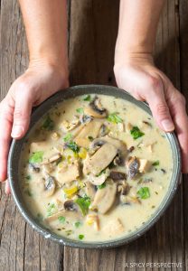 Bowl of Creamy Chicken Mushroom Soup held with hands