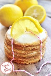 stack of keto lemon sugar cookies wrapped with twine and topped with a sliced lemon