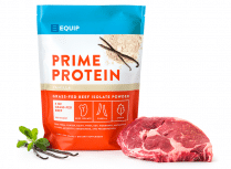 a pack of equip vanilla protein powder beside a slab of raw meat and vanilla pods