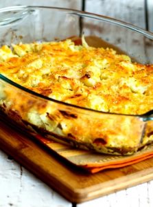 Cauliflower Gratin with Sharp Cheddar and Parmesan in a clear glass baking dish