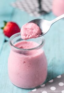 Easy Paleo Strawberry Mousse in a small jar scooped with a spoon