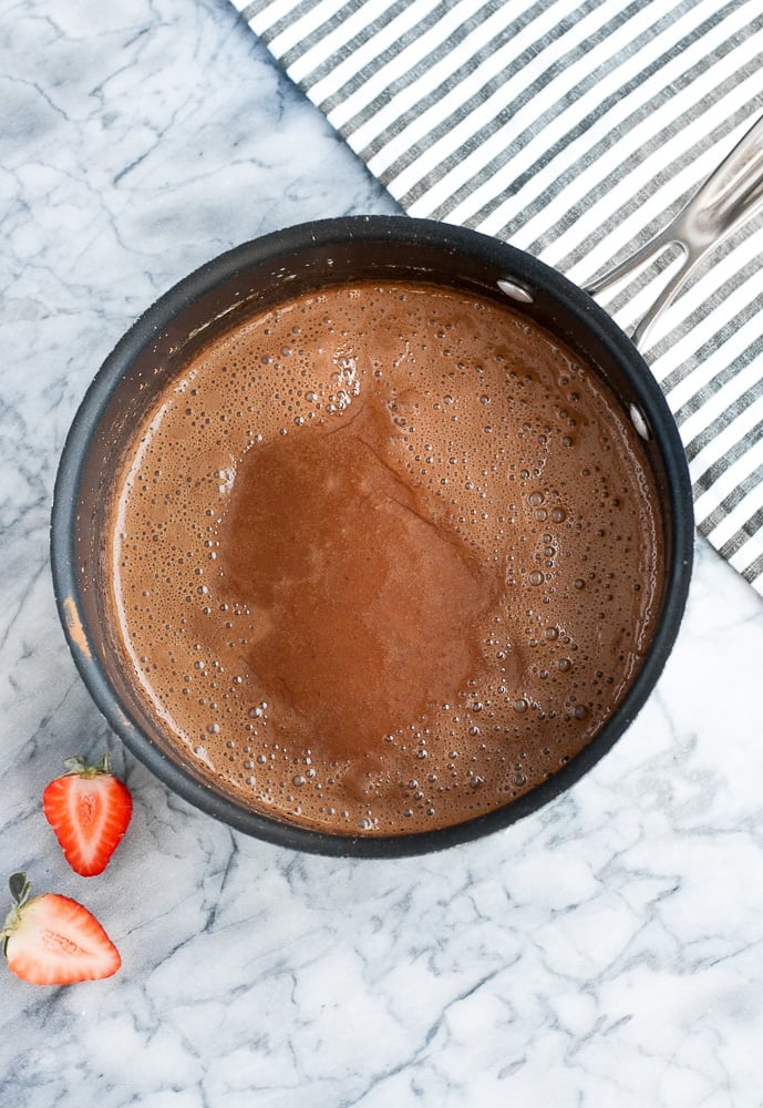 cocoa powder and strawberry extract whisked with heated mixture of heavy cream, monk fruit sweetener, gelatin powder, and espresso powder in a saucepan