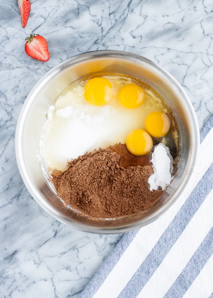 Low Carb Chocolate Strawberry Cupcakes ingredients in a stainless steel mixing bowl pre-mixing