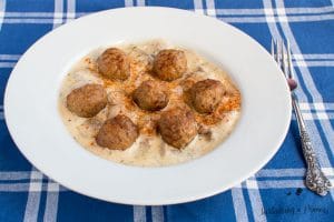 Bowl with Low-Carb Beef Stroganff Meatballs on a blue plaid surface