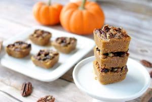 seven Pumpkin Pie Bites in small serving plates with pumpkin decor in the background