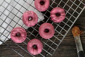 Red Velvet Doughnuts on a baking rack
