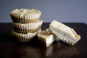 three Vegan Keto Cheesecake Fat Bombs stacked together and cut in half