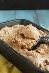 Ultimate Fat Bomb Ice Cream in a baking tin scooped with a scooper