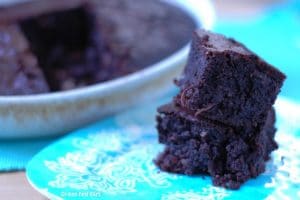 Paleo and Keto Fat Bomb Coconut Brownies on a blue saucer