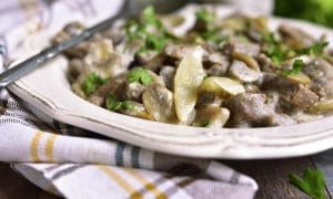 Side view of Beef Stroganoff with Sour Cream on a vintage white plate