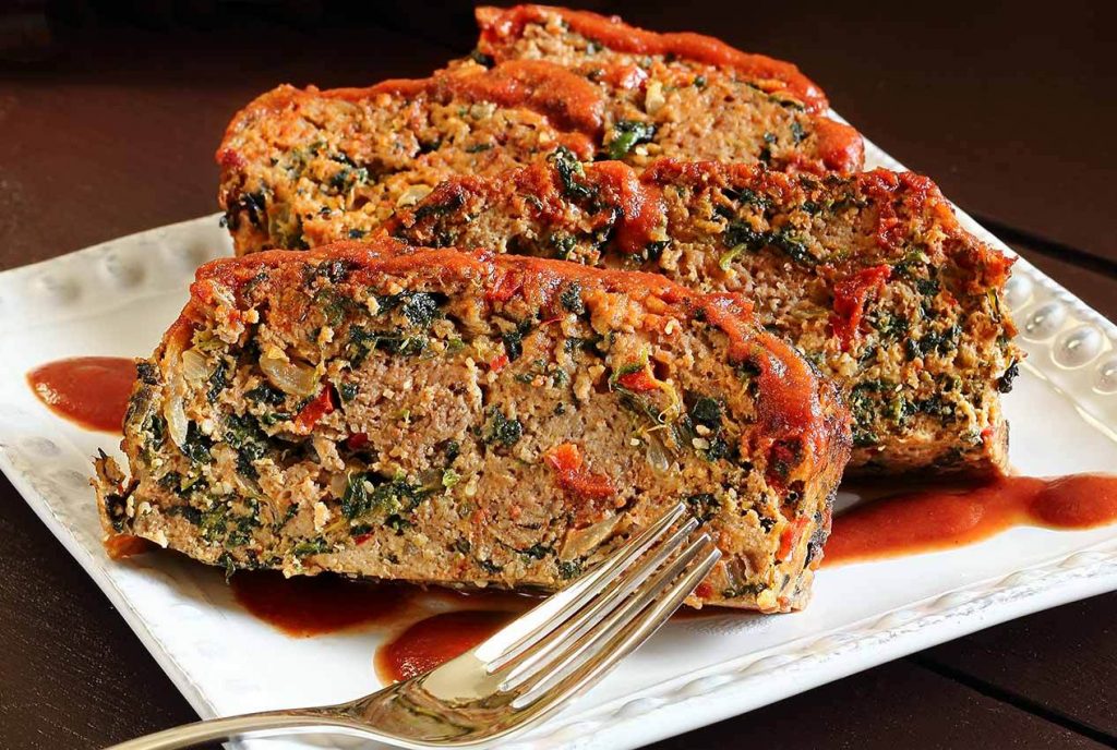 Zesty Paleo Meatloaf on a square plate beside a fork