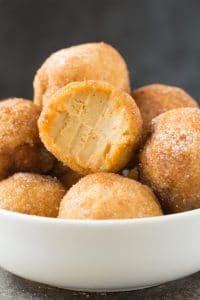 No Bake Keto Low Carb Pumpkin Pie Bites on a cup with one piece bitten through