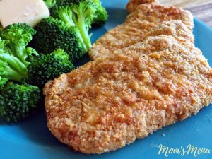 crispy air fryer pork chops on a light blue plate with broccoli