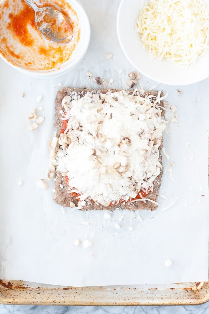 baked ground pork mixture with tomato sauce, mozzarella cheese, with chopped mushrooms, grated parmesan