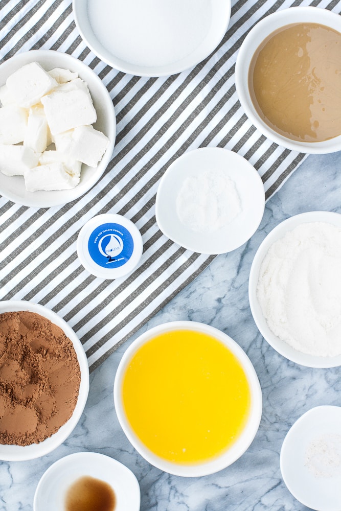 Chocolate Truffle Fat Bombs ingredients in separate shallow dishes and bowls