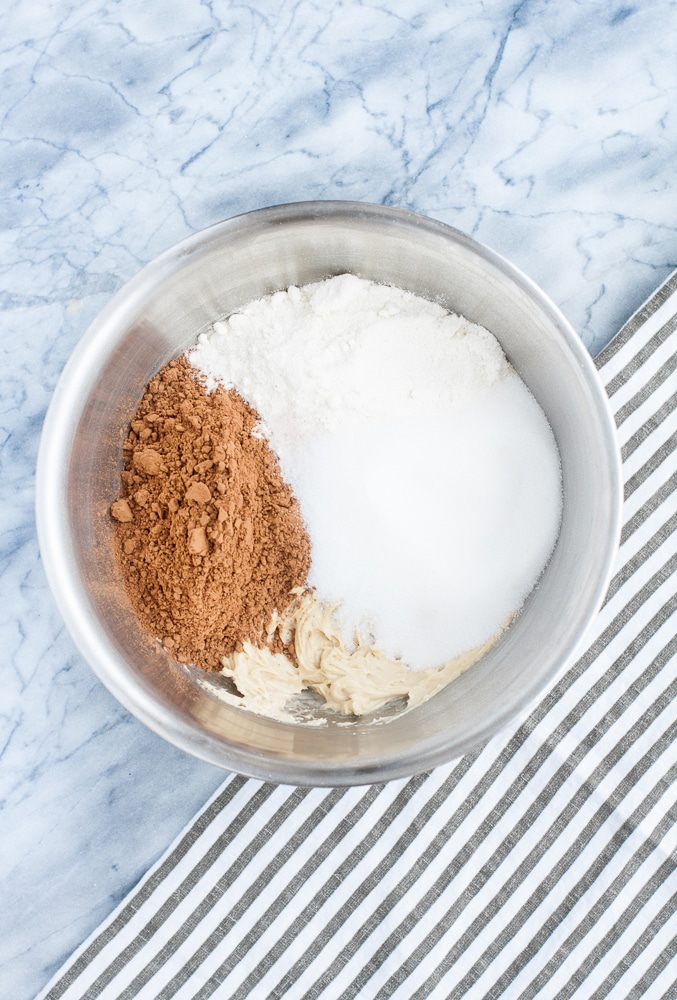 cocoa powder, coconut flour, vanilla extract, and salt poured into mixing bowl with cream cheese, butter, and SunButter mixture