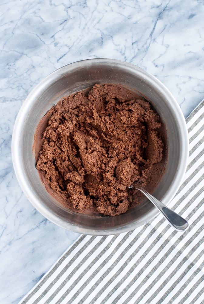 Chocolate Truffle Fat Bombs with CBD isolate powder mixed together in a stainless steel mixing bowl