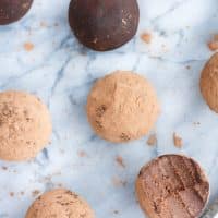 seven Chocolate Truffle Fat Bombs with one piece bitten through