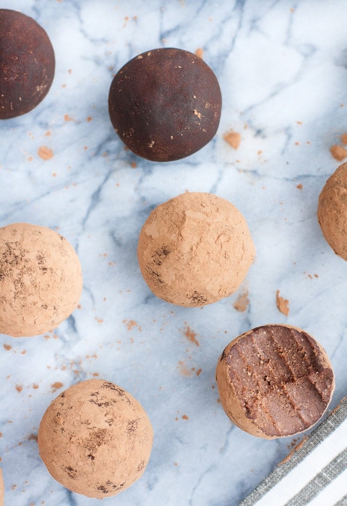 seven Chocolate Truffle Fat Bombs with one piece bitten through