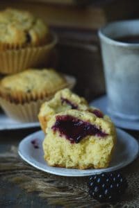 low carb blackberry filled lemon almond flour muffins beside a blueberry