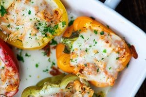 chicken parmesan stuffed peppers on a baking dish