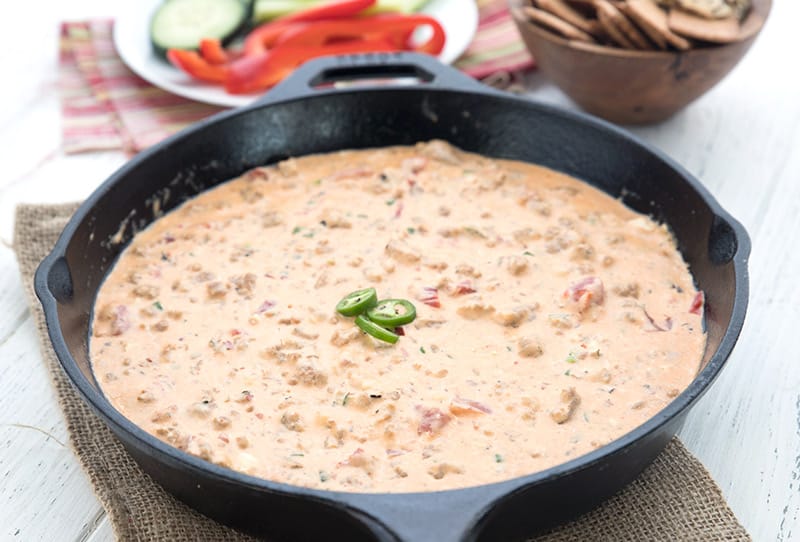 cast iron skillet with cheesy sausage dip