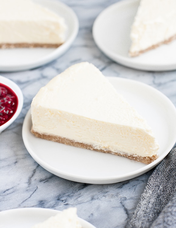 plain slices of cheesecake on small white plates