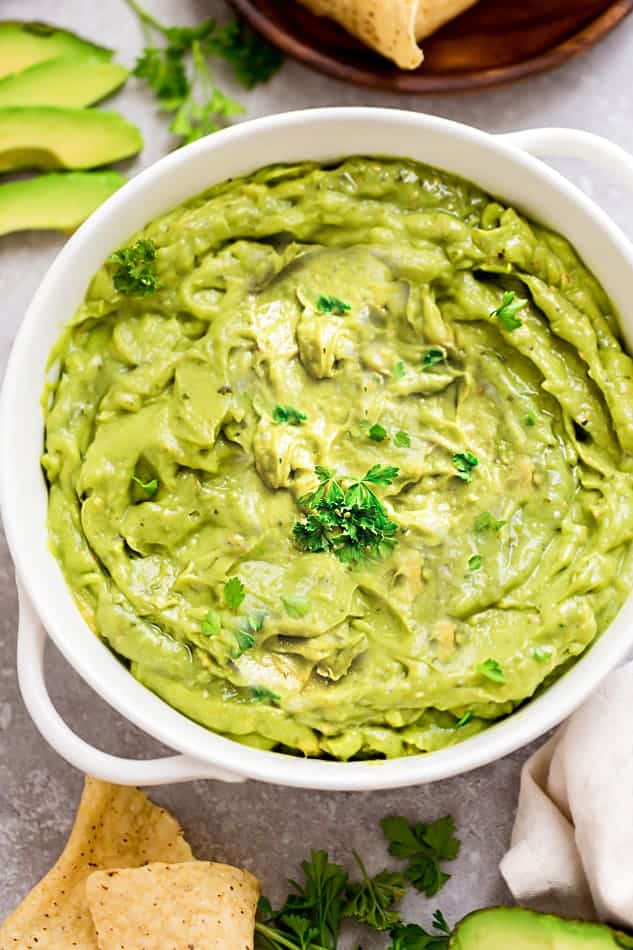 white bowl of creamy homemade guacamole