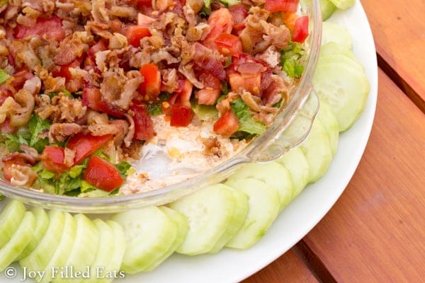 glass dish with BLT dip and cucumbers